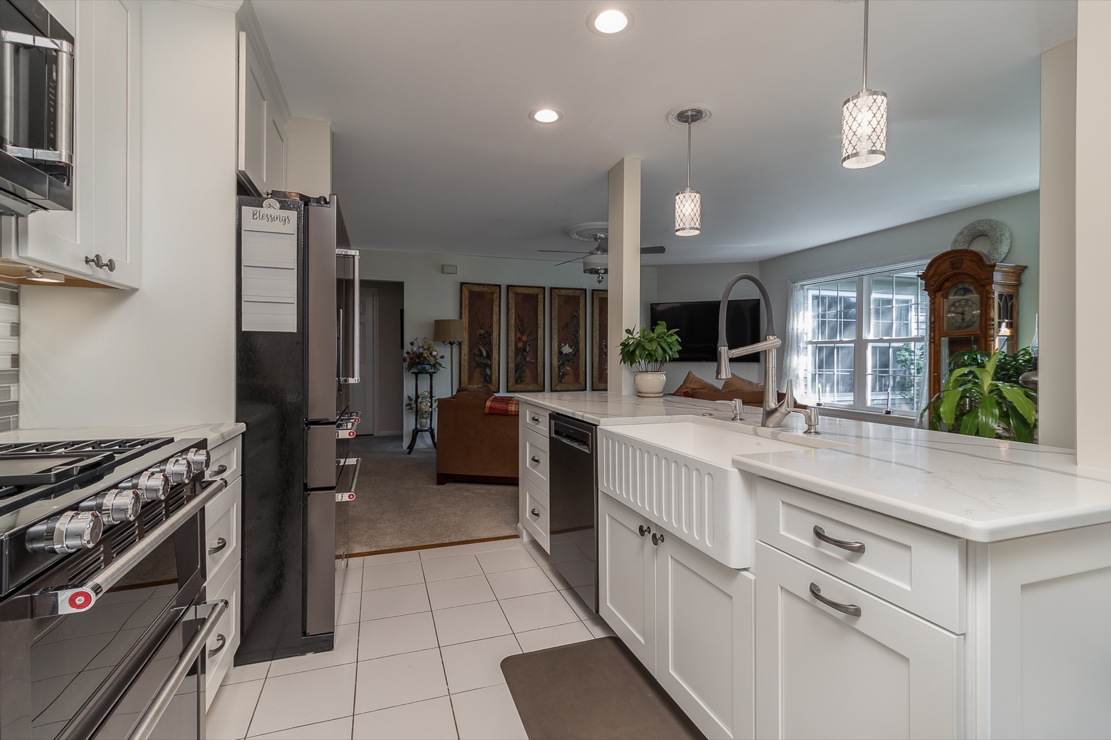 Completed Aurora kitchen renovation — Farmhouse sink and open living connection