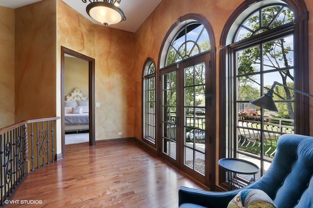 Hinsdale custom home — Den with arched windows and balcony access
