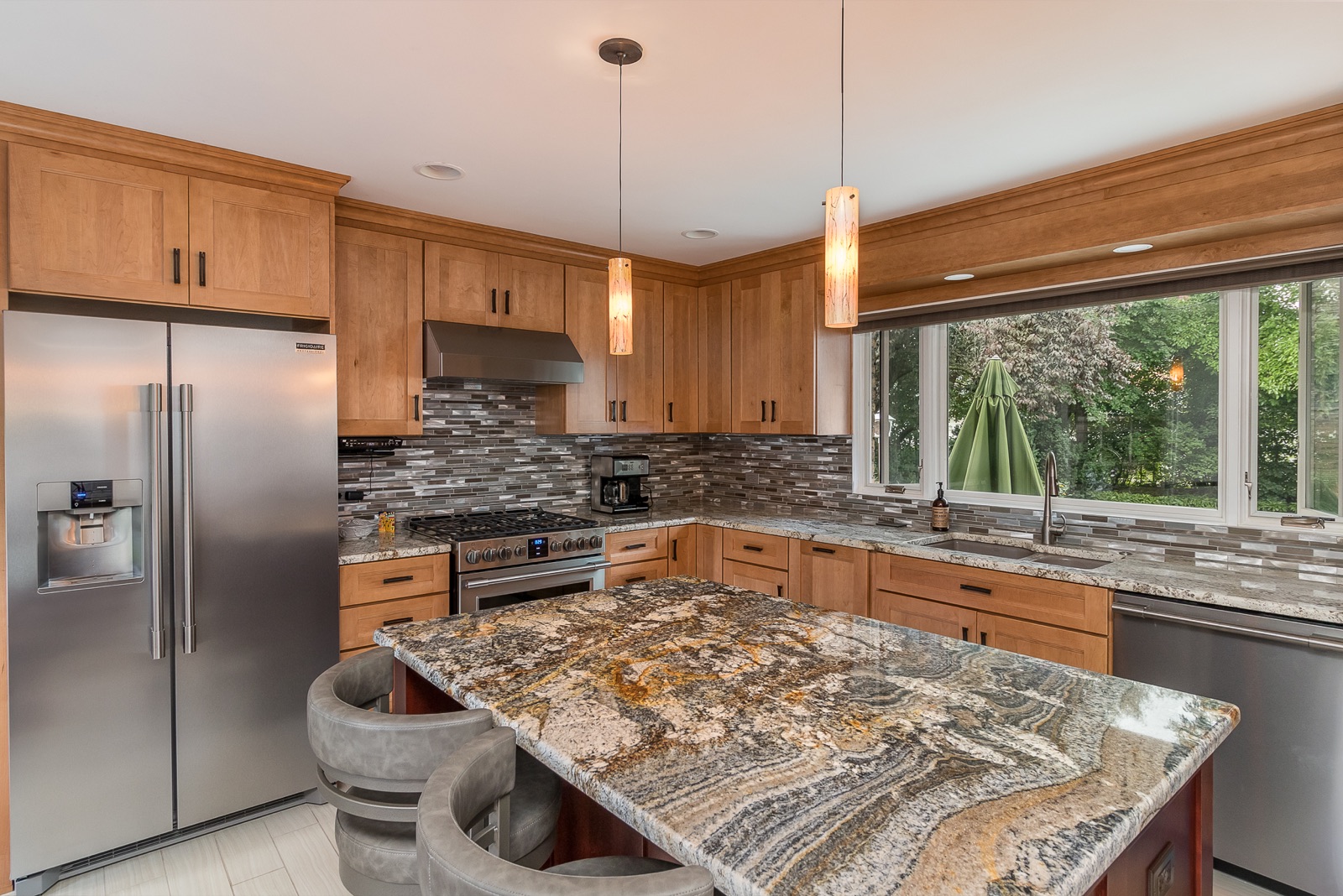 Completed Lincolnwood kitchen renovation — Stone island and appliance wall