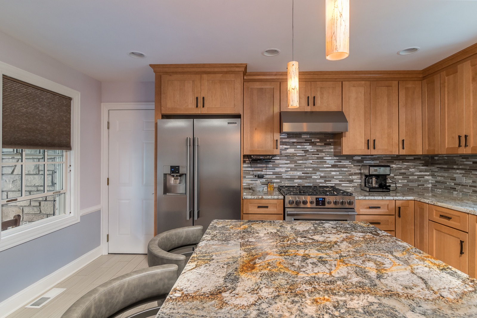 Completed Lincolnwood kitchen renovation — Range wall and pendant lighting