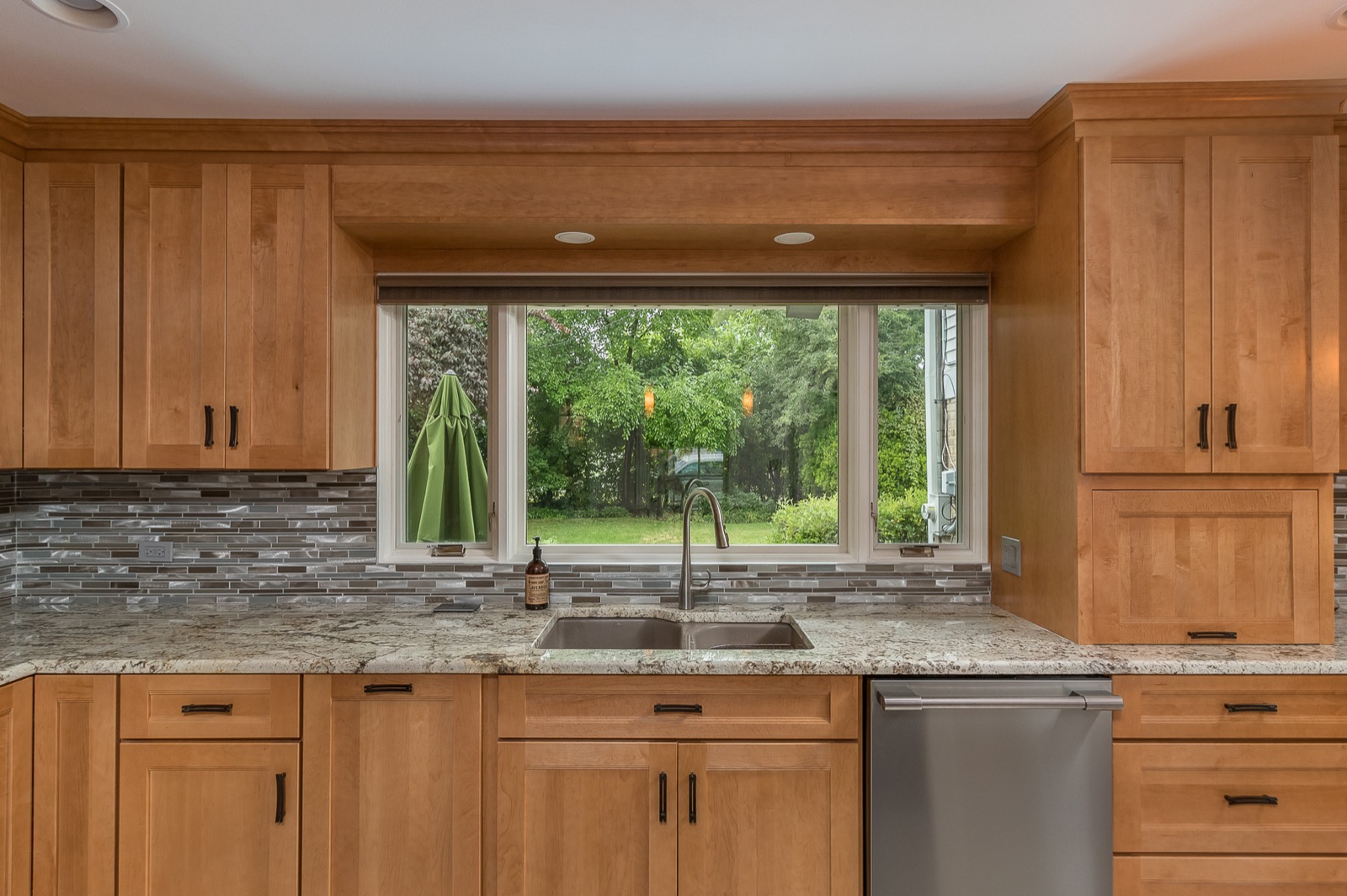 Completed Lincolnwood kitchen renovation — Garden-facing sink and cabinetry