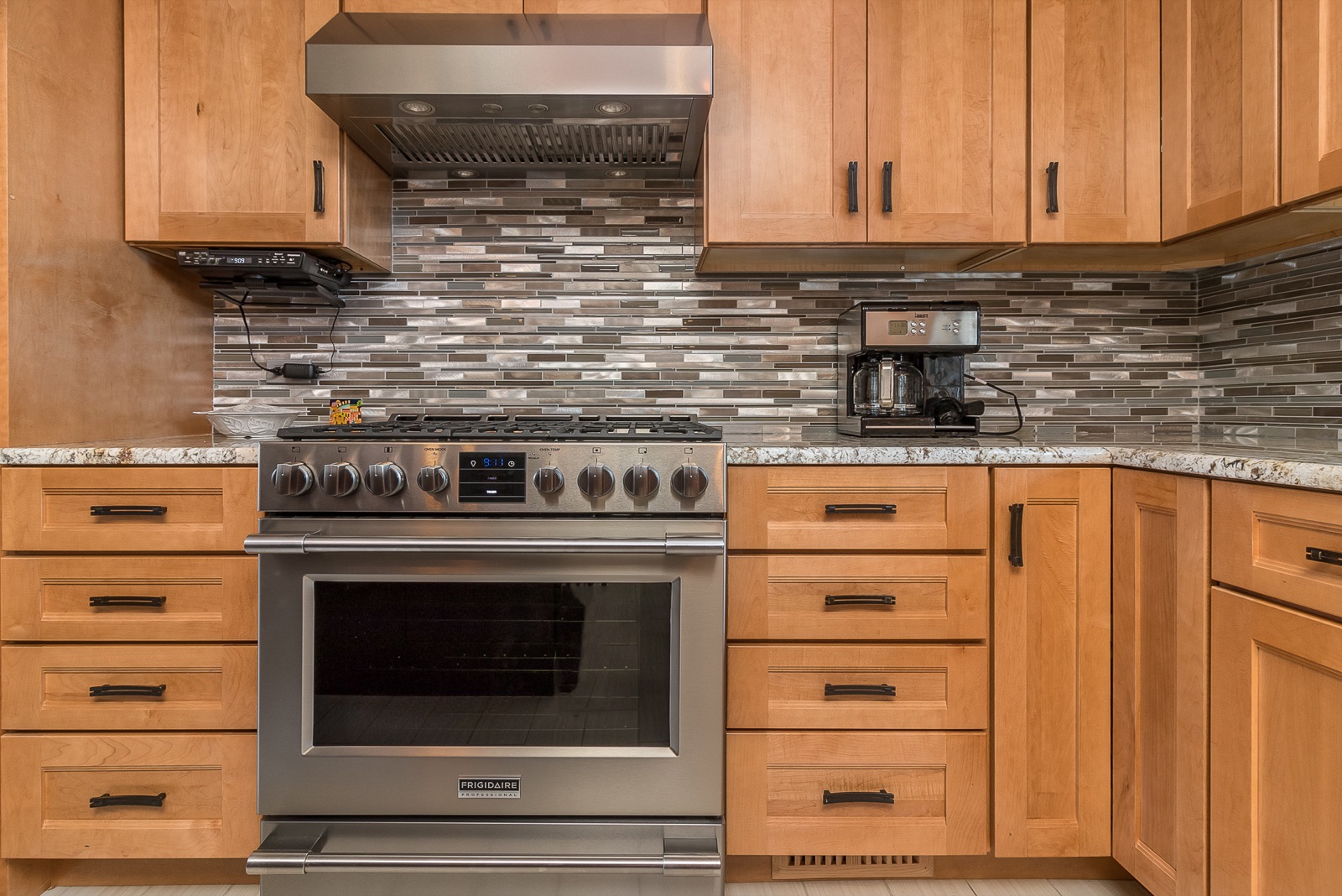 Completed Lincolnwood kitchen renovation — Range hood and detailed backsplash