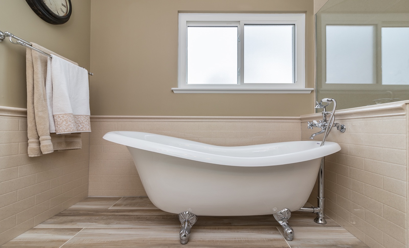 Completed Naperville master bath renovation — Clawfoot tub and warm tile surround